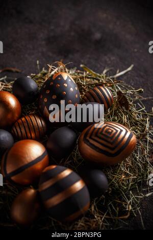 Easter composition with gold and black eggs in nest Stock Photo