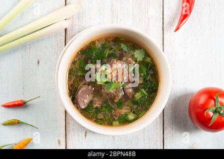Asian bone soup or sup tulang, popular traditional malay dish. Top view flat lay. Stock Photo