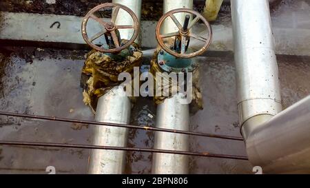 Breakthrough laying on the water supply of the formation water. Leakage of the flange connection on the shut-off valve Stock Photo