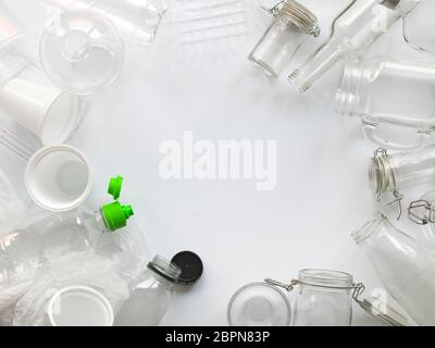 many different empty glass and plastic bottles lying on a white background Stock Photo