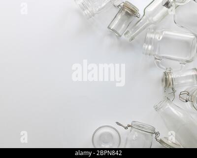 many different empty glass bottles lying on a white background Stock Photo