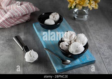 Dairy and stracciatella ice cream in black dessert bowl Stock Photo