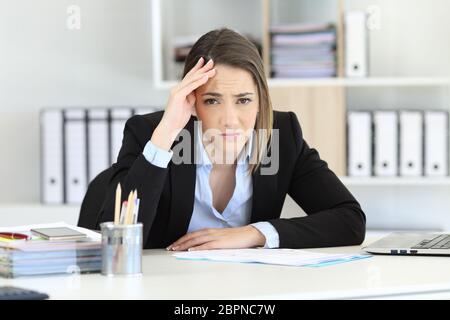 Front view portrait of a worried executive looking at camera at office Stock Photo