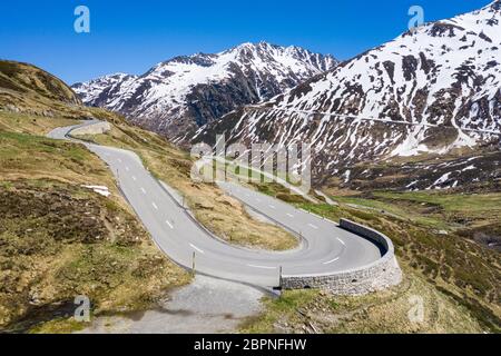 Hairpin curve along the Oberalp pass road between Uri and Graubünden cantons in the alps in Switzerland on sunny spring day Stock Photo