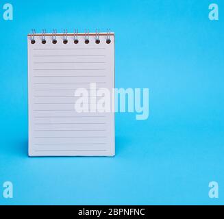 open blank notebook in line on a blue background, copy space Stock Photo