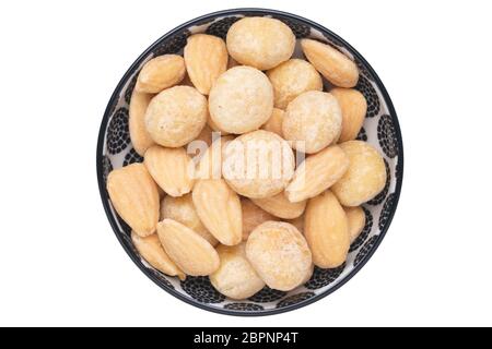 Nuts background. Close-up of roasted and salted macadamias and almonds nuts in ceramic bowl isolated on a white background. Gourmet nut mix with macad Stock Photo