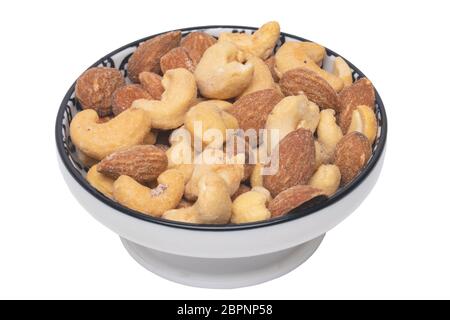 Nuts background. Close-up of roasted and salted almonds and cashew nuts in a ceramic bowl isolated on a white background. Gourmet nut mix with almonds Stock Photo
