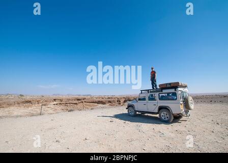 Road trip through the Namibian desert in a 4WD with a roof top tent. Adventure African holiday. Stock Photo