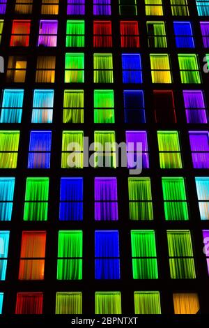 Colored windows texture. Windows illuminated by neon lights background ...