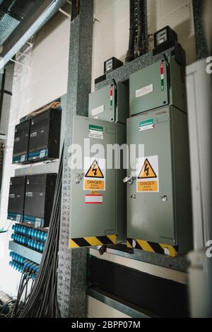 Close up shot of electrical enclosure boxes and power switches in the basement of a music studio, Stock Photo