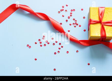 Surprise box with untied red ribbon on a blue backgroundon. Flat lay Stock Photo