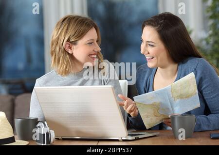 Happy friends planning travel online talking about vacation at home Stock Photo