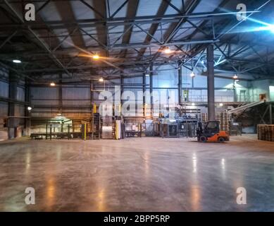 Pallet racks inside a cement plant. Loading shop of a cement plant. Stock Photo