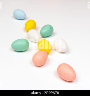 colored easter eggs with little chicks on a white surface Stock Photo