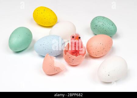 colored easter eggs with little chicks on a white surface Stock Photo