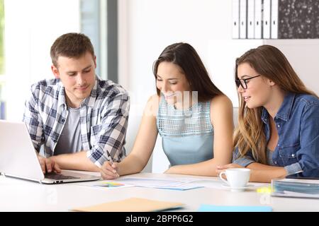 Three happy employees coworking reading documents at office Stock Photo