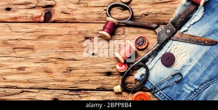 Sewing kit.Spools of thread and basic sewing tools on wooden table.Long banner Stock Photo