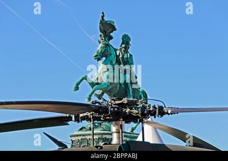 equestrian monument of emperor Charles at the heroes place in Vienna behind the rotor of a modern combat helicopter, Austria