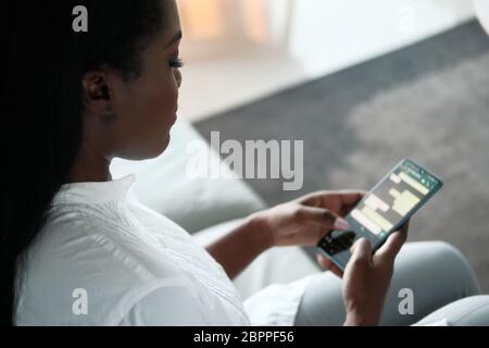 Black Woman Using Mobile Phone For Text Messaging Stock Photo
