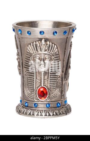 Egyptian art. Close-up of egyptian metalic cup with gems isolated on a white background. Egypt souvenir. Macro. Stock Photo