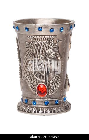 Egyptian art. Close-up of egyptian metalic cup with gems isolated on a white background. Egypt souvenir. Macro. Stock Photo