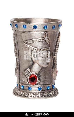 Egyptian art. Close-up of egyptian metalic cup with gems isolated on a white background. Egypt souvenir. Macro. Stock Photo
