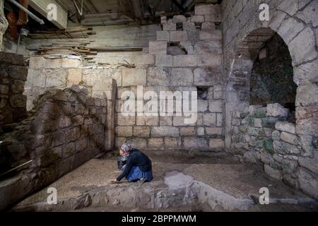 Jerusalem, Israel. 19th May, 2020. An Israeli archaeologist works at an archaeological excavation site in Jerusalem, on May 19, 2020. Israeli archaeologists have discovered a unique 2,000-year-old subterranean system, hewn in the bedrock near the Western Wall Plaza in ancient Jerusalem, the Israel Antiquities Authority (IAA) said on Tuesday. (JINI via Xinhua) Credit: Xinhua/Alamy Live News Stock Photo