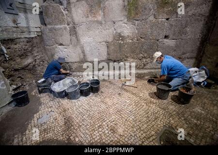 Jerusalem, Israel. 19th May, 2020. Israeli archaeologists work at an archaeological excavation site in Jerusalem, on May 19, 2020. Israeli archaeologists have discovered a unique 2,000-year-old subterranean system, hewn in the bedrock near the Western Wall Plaza in ancient Jerusalem, the Israel Antiquities Authority (IAA) said on Tuesday. (JINI via Xinhua) Credit: Xinhua/Alamy Live News Stock Photo