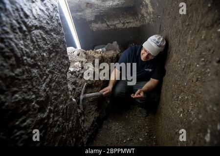 Jerusalem, Israel. 19th May, 2020. An Israeli archaeologist works at an archaeological excavation site in Jerusalem, on May 19, 2020. Israeli archaeologists have discovered a unique 2,000-year-old subterranean system, hewn in the bedrock near the Western Wall Plaza in ancient Jerusalem, the Israel Antiquities Authority (IAA) said on Tuesday. (JINI via Xinhua) Credit: Xinhua/Alamy Live News Stock Photo