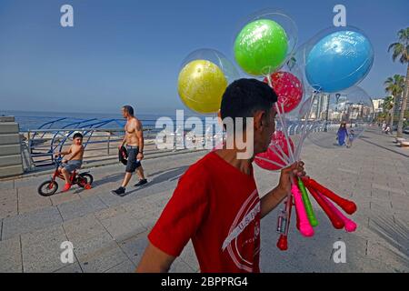 Beirut, Lebanon. 19th May, 2020. A vendor sells balloons amid the COVID-19 pandemic at the Corniche of Beirut, Lebanon, on May 19, 2020. Lebanon's number of COVID-19 infections increased on Tuesday by 23 cases to 954, while the death toll remained unchanged at 26, the National News Agency reported. Credit: Bilal Jawich/Xinhua/Alamy Live News Stock Photo