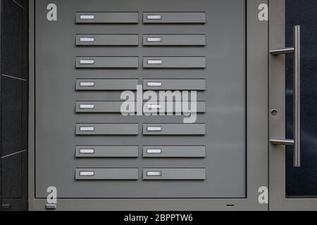 Metal Door bells with empty name tags. Doorbell with no names next to the door of apartment's entrance. Stock Photo
