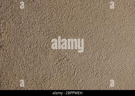 Rough bumpy brown concrete plaster texture background. Stock Photo