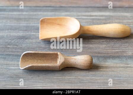 Two empty transfer scoops on the wooden table Stock Photo