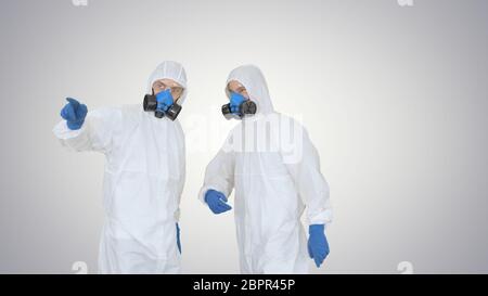 Disinfection team is called to help on gradient background. Stock Photo