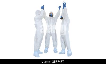 Doctors in hazamat suits stacking hands Team work on white background. Stock Photo