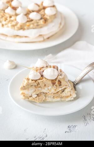 Pavlova cake with caramel and almonds on the wooden background Stock Photo