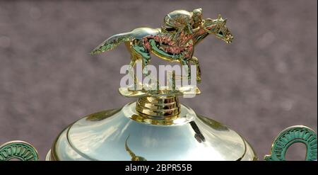 Classic Gold Cup with the image of a jockey on a horse, a pedestal with the engraved inscription '1st place'. Stock Photo