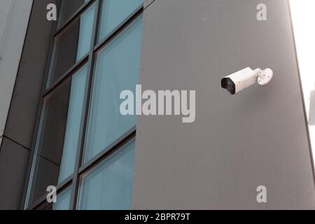 CCTV camera on the wall of an office building. Territory protection concept Stock Photo
