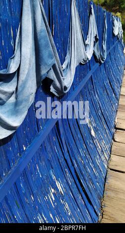 cracked blue stripes of paint fence Stock Photo