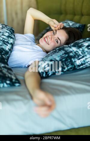 Well Rested Young Couple Stretching on Bed in Morning Stock Photo