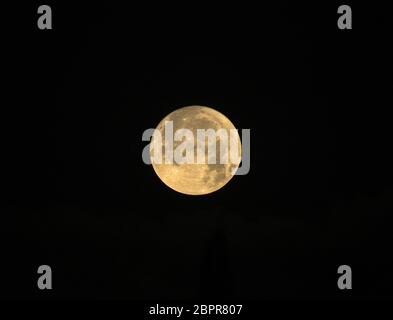 Full Moon named Cold Moon rising on black background Stock Photo