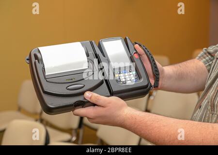 Man Holding Mobile Barcode Printer and Scanner Set Device Stock Photo