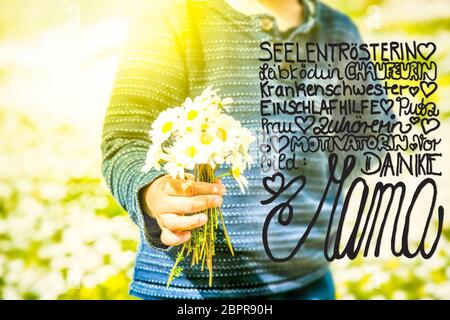 German Calligraphy Danke Mama Means Thank You Mom. Cute Little Kid Is Holding A Bouquet Of Daisy Flower. Sunny And Spring Flower Field. Stock Photo