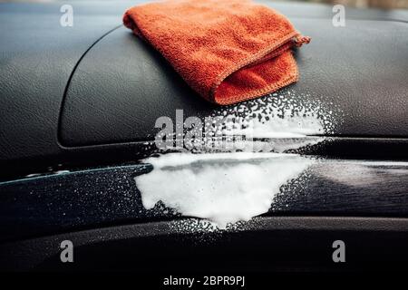 Clean the cockpit of the car with a spray Stock Photo - Alamy