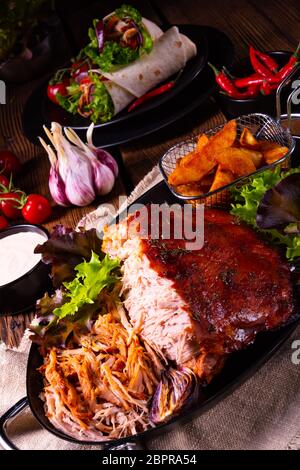 delicious pulled pork with baked potato quarters Stock Photo