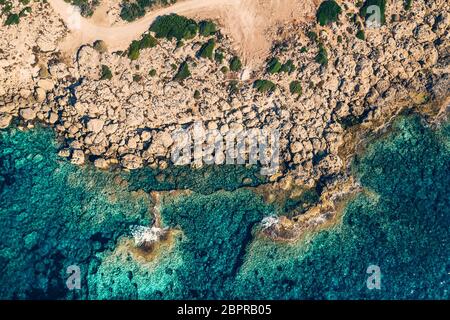 Sea aerial top view, amazing mediterranean nature background. Wild rocky mountains and azure clear water, drone shot. Stock Photo