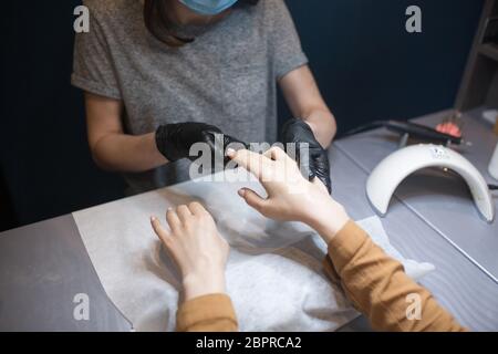 Beauty salon, applying moisturizing cream on client hands and massaging. Manicure at the salon. SPA manicure, hand massage and body care. Close up Stock Photo