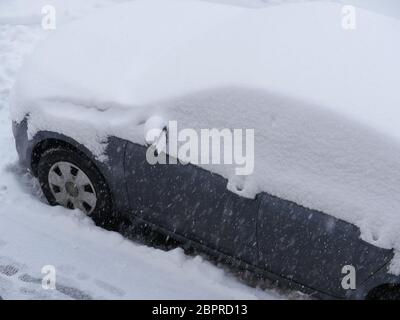 snowfall, passenger car covered with a thick layer of snow Stock Photo