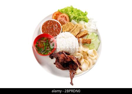 Nasi lemak kukus with quail meat, popular traditional Malaysian local food. Isolated on white background. Flat lay top down overhead view. Stock Photo