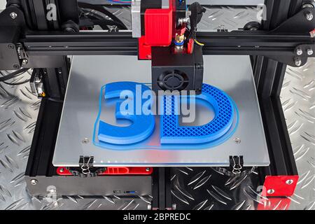 Red black 3D printer printing blue logo symbol on metal diamond plate future technology modern concept background Stock Photo